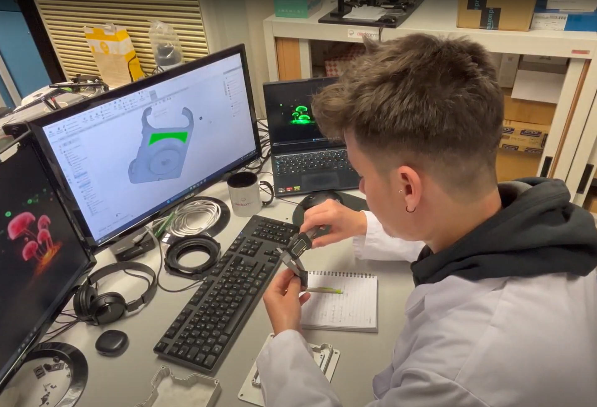 Oledcomm mechanical engineer performs precision measurements for the design of SatelLife