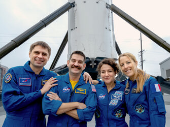 Crew-12 in front of a SpaceX booster
